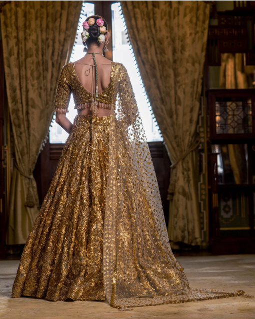 Rouen Golden Lehenga Set With A Cropped Blouse Adorned With Sequins